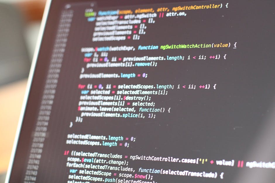 A close-up image of a computer screen displaying lines of colorful programming code, including different syntax highlighting with text in shades of blue, pink, green, and white. The code appears to be
